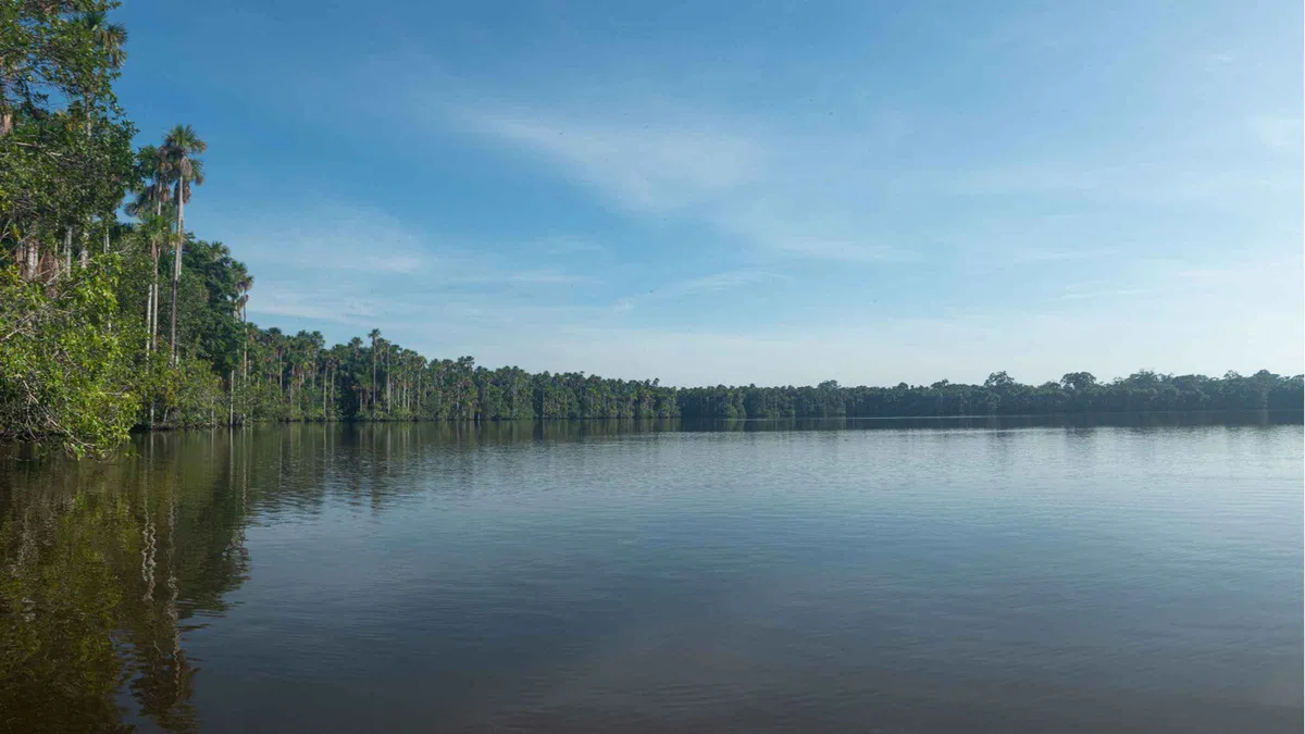 Kayaks on the Madre de Dios River beside the rainforest on a 2-day Puerto Maldonado Amazon tour with a lodge stay, Peru